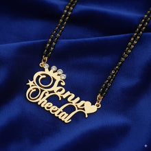 Gold name necklace with 'Anjali Sheetal' on a blue fabric background