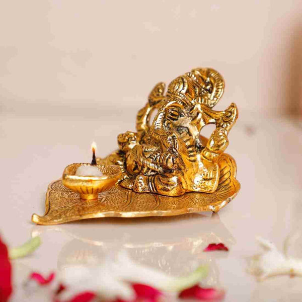 Gold Finish Metal Ganesha in Pipal Leaf with Diya