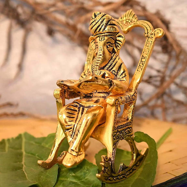 Lord Ganesha Golden Statue Sitting On A Chair